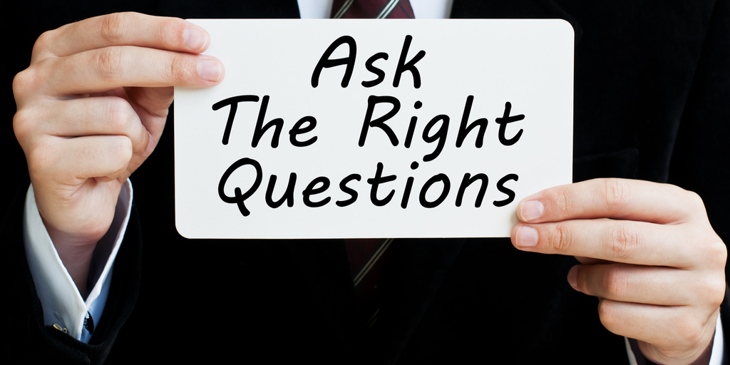 businessman-holding-sign-ask-the-right-questions